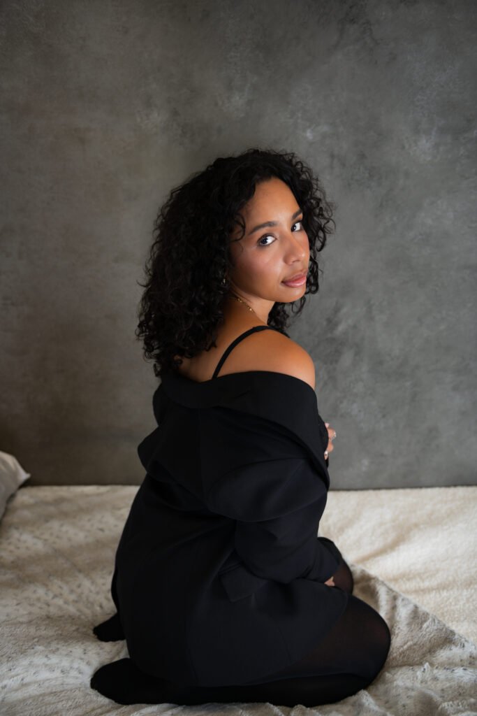 Woman with natural hair in black top, elegant boudoir portrait, Dallas