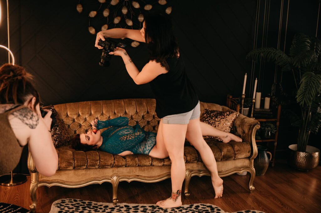 Boudoir photographer capturing a client on a vintage couch during a DFW photo session